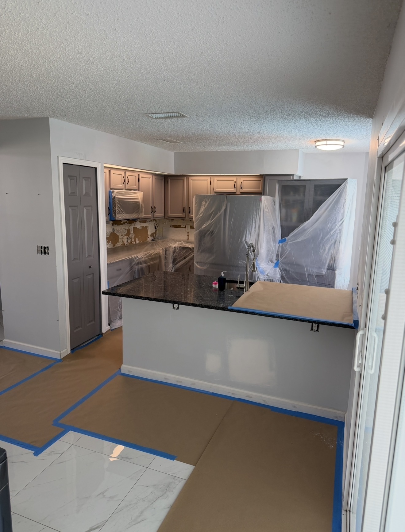Kitchen sealed off — counters, appliances and floors protected