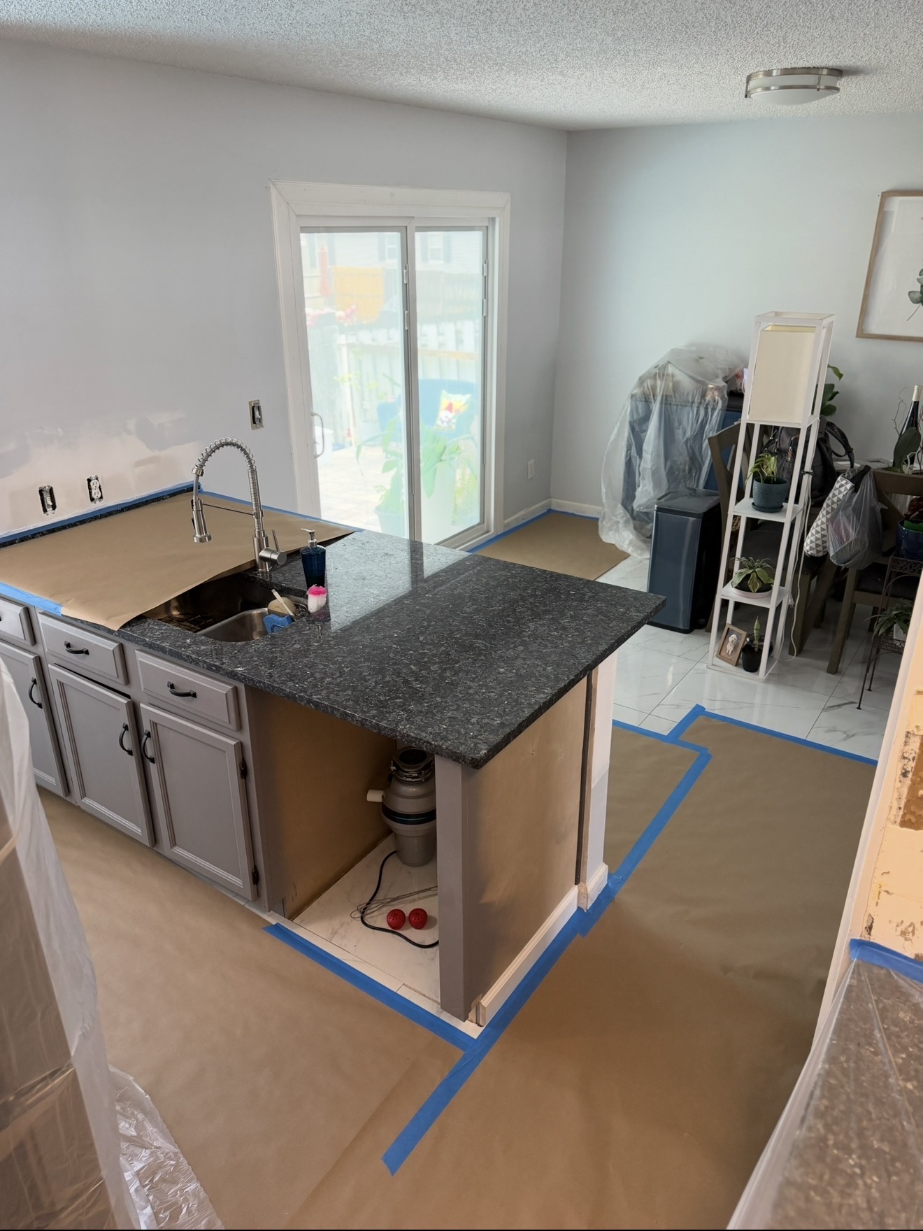 Island, sink and cabinetry fully covered